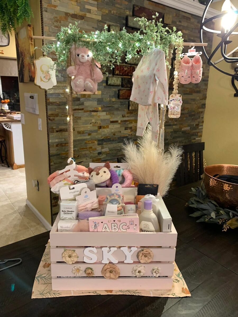 Baby shower crate arrangement with pink florals