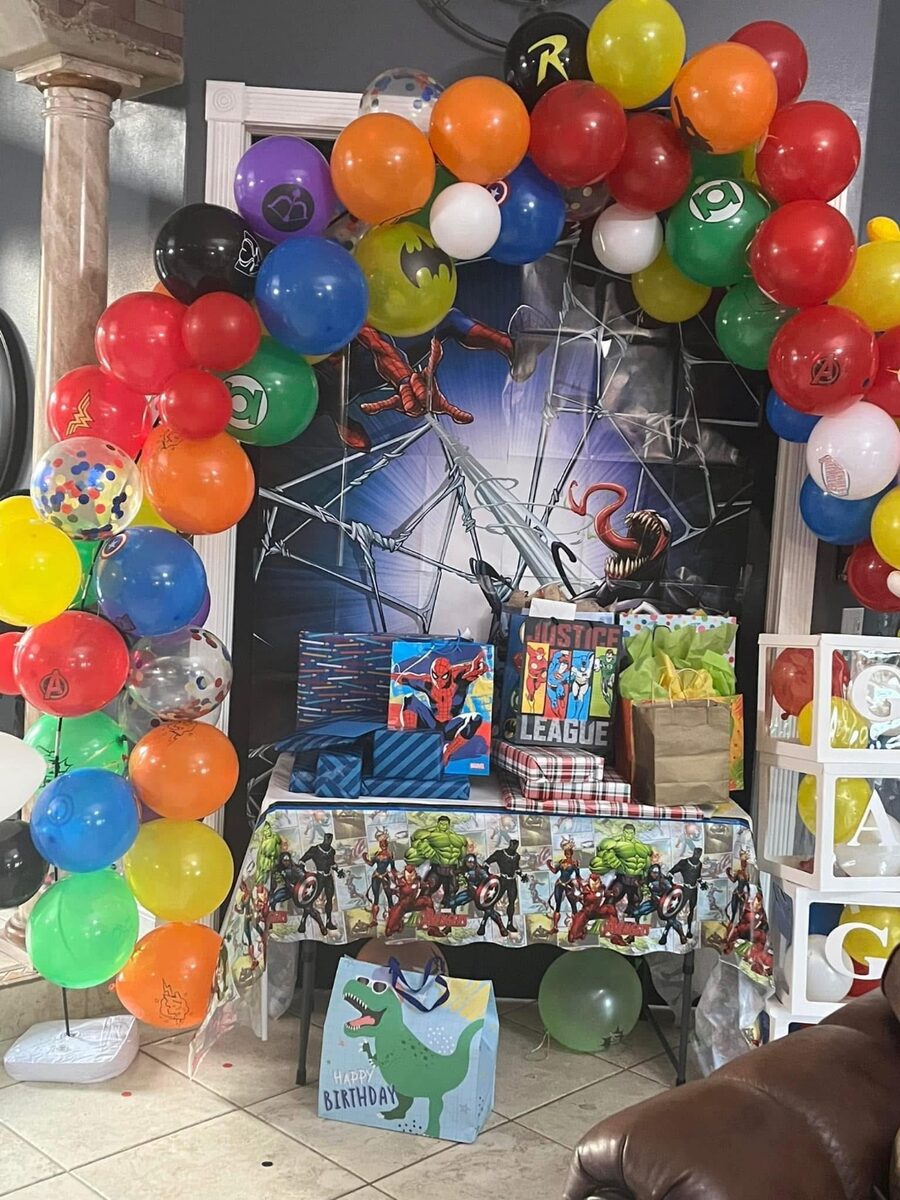 Superhero themed arch with a gift display